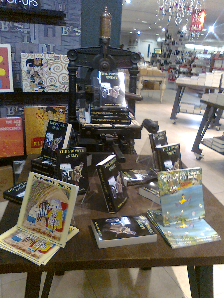 Image of books arranged on old printing press